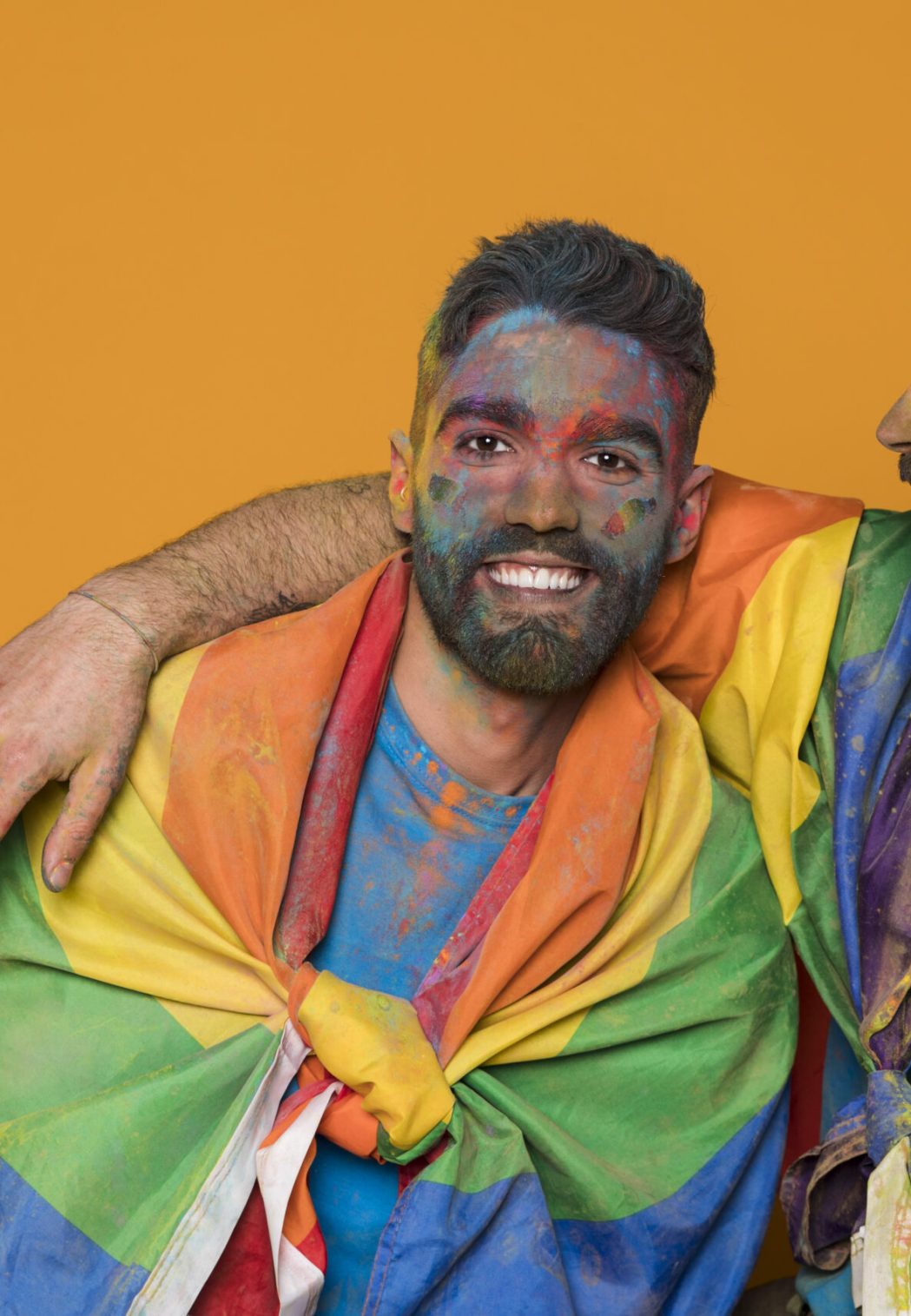 couple-homosexual-men-covered-by-lgbt-flag-colorful-painted