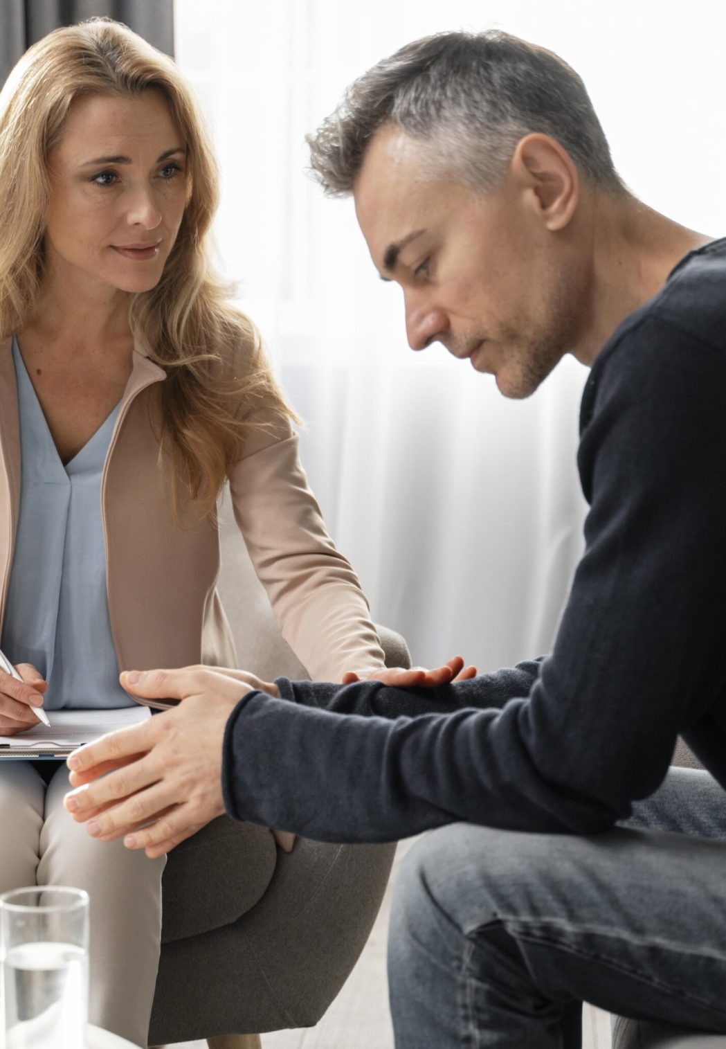 mid-shot-woman-therapist-comforting-patient